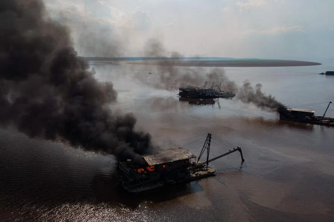 Members of the Federal Police destroying illegal mining dredgers during an operation on the banks of the Rio Negro river in Manaus, Brazil on Oct 5.
