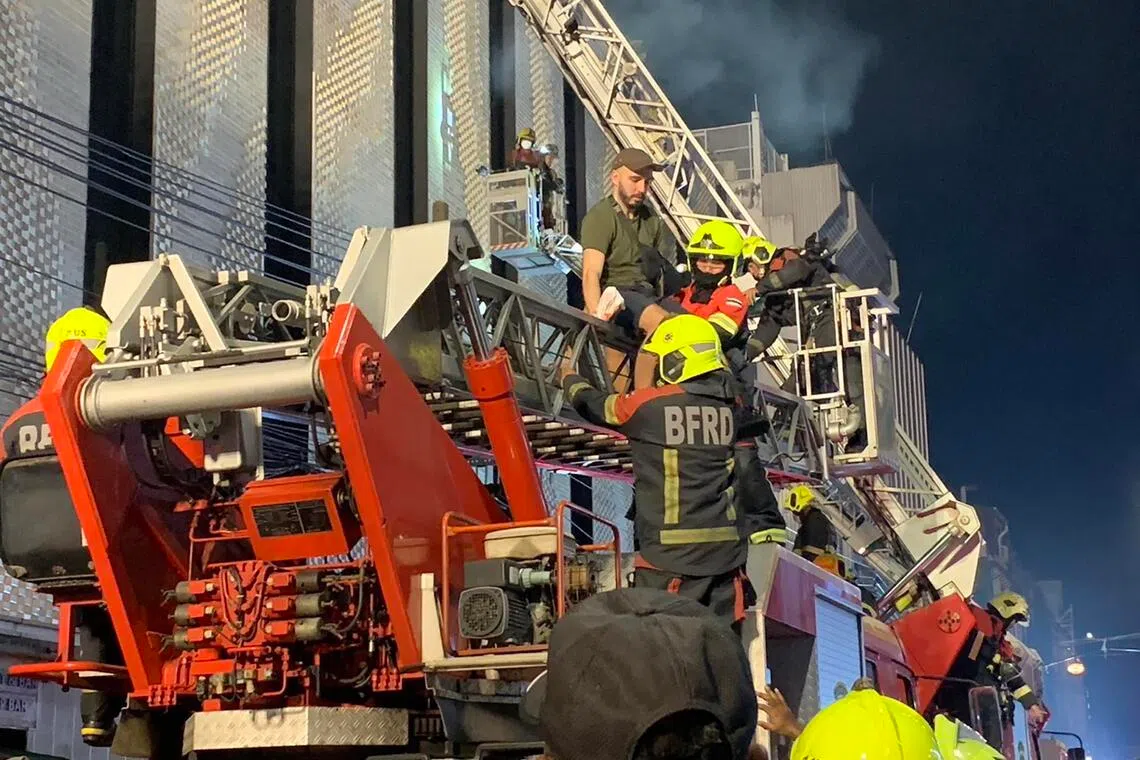 Bangkok’s Fire and Rescue Department deploys three aerial ladder trucks to rescue guests trapped inside The Ember Hotel on Dec 29, 2024.