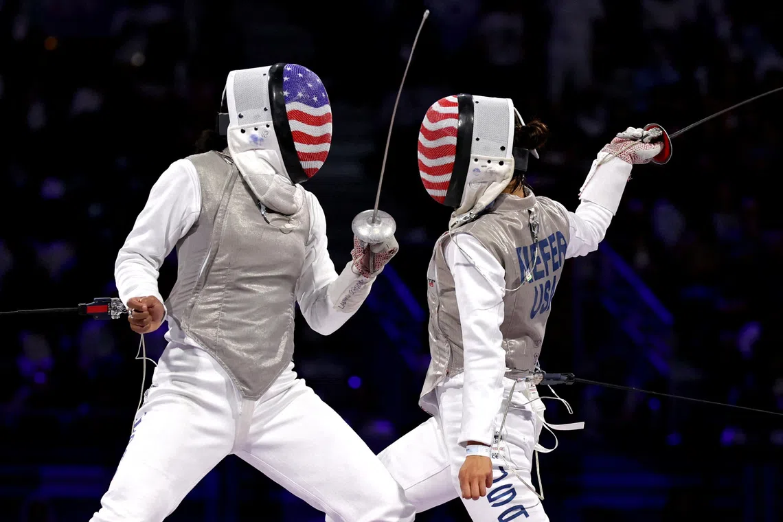 FILE PHOTO: Paris 2024 Olympics - Fencing - Women's Foil Individual Gold Medal Bout - Grand Palais, Paris, France - July 28, 2024. Lee Kiefer of United States in action with Lauren Scruggs of United States. REUTERS/Maye-E Wong/File Photo