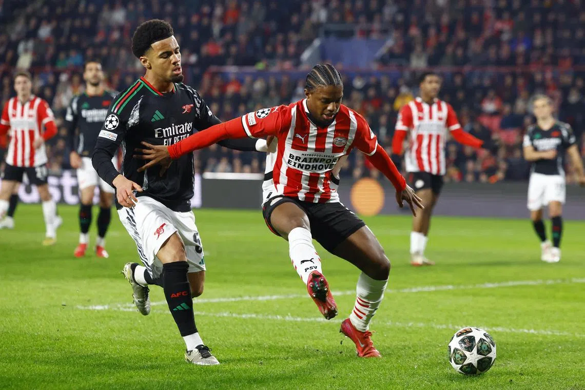 Arsenal's Ethan Nwaneri in action with PSV Eindhoven's Tyrell Malacia during the Champions League.