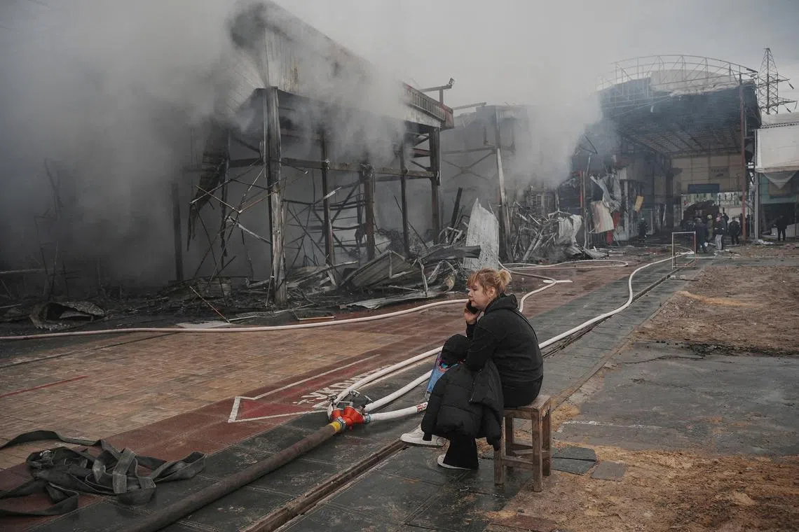 FILE PHOTO: A vendor sits at the site of the Barabashovo market hit by Russian drone strike, amid Russia's attack on Ukraine, in Kharkiv, Ukraine, May 6, 2025. REUTERS/Viktoriia Yakymenko/File Photo