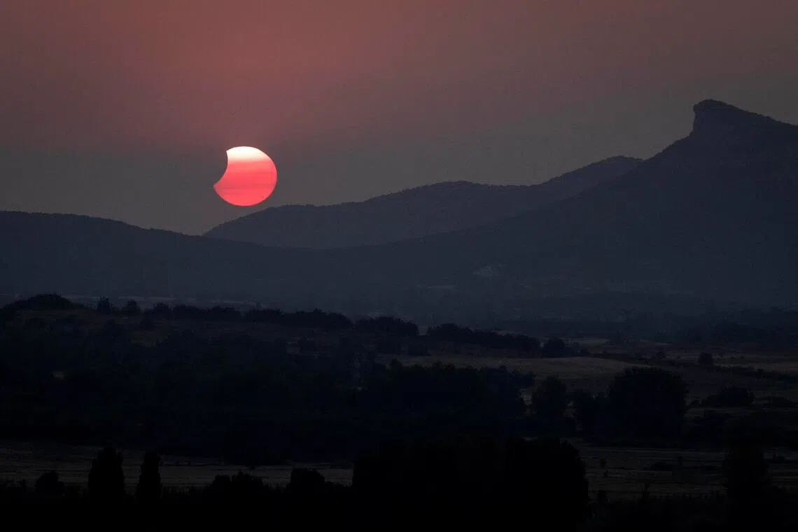 The moon passes away from the sun after a total solar eclipse in Castrillo de la Reina, Spain, on Aug 12.
