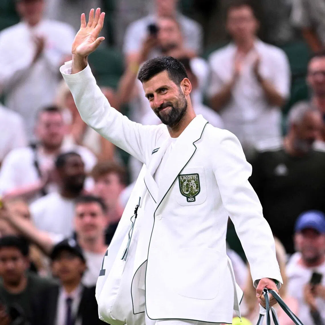 Serbia’s Novak Djokovic wearing a personalised cream jacket as he leaves the court after beating Greece’s Stefanos Tsitsipas at Wimbledon on July 1.