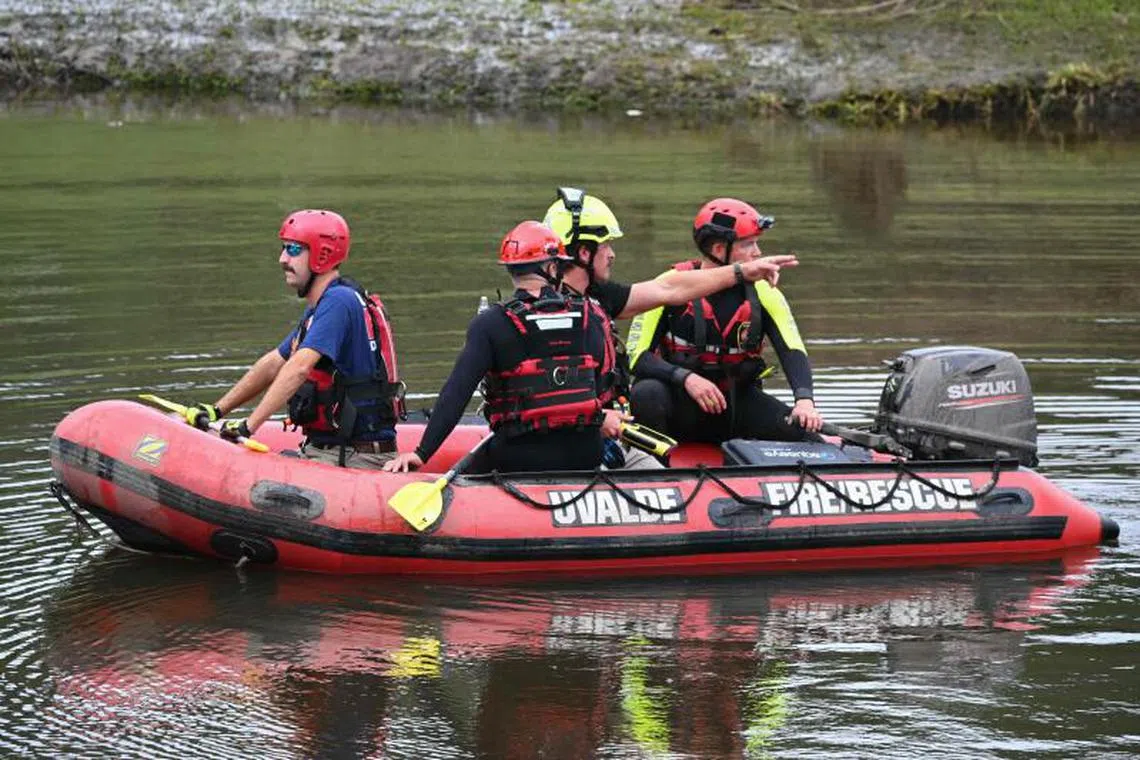A search and rescue team looks for people along the Guadalupe River near Camp Mystic in Hunt, Texas, on July 7, 2025, following severe flash flooding that occurred during the July 4 holiday weekend. Rescuers in Texas continue to race against time to find dozens of missing people, including children, swept away by flash floods that killed more than 80 people, with forecasters warning of new deluges. In a terrifying display of nature's power, the rain-swollen waters of the Guadalupe River reached treetops and the roofs of cabins in Camp Mystic as girls slept overnight on Friday, July 4, washing away some of them and leaving a scene of devastation. (Photo by RONALDO SCHEMIDT / AFP)