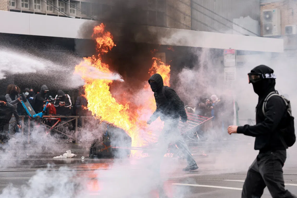 A person is sprayed by a water cannon as protesters, including students, attend a demonstration during a nationwide strike against the Belgian government's austerity measures and budget cuts, in Brussels, Belgium, October 9, 2026. REUTERS/Stephanie Lecocq