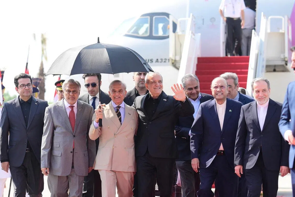 Iranian President Masoud Pezeshkian waving as he is welcomed to Pakistan on June 23 by Prime Minister Shehbaz Sharif and President Asif Ali Zardari.