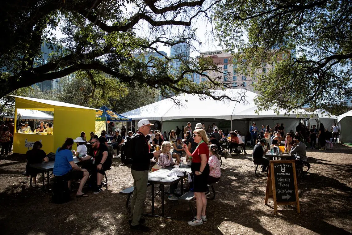 FILE PHOTO: People attend the SXSW (South by Southwest) conference and festivals in Austin, Texas, U.S. March 14, 2022.  REUTERS/Montinique Monroe/File Photo