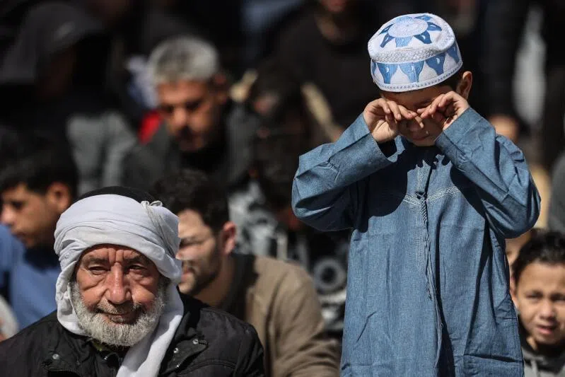 A Palestinian Muslim child rubs his eyes as he gathers with worshippers during the first Friday noon prayers of the holy month of Ramadan in Gaza City, on Feb 20, 2026.