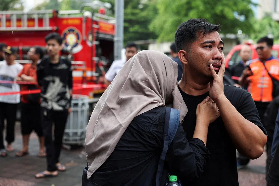 A man reacting as he looks for his sister following a deadly train crash. 