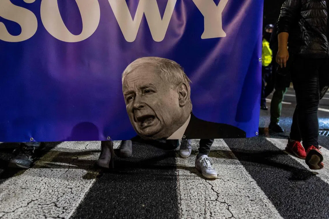 Protesters march with a banner showing Jaroslaw Kaczynski, leader of the Law and Justice party, during the 'Crisis Strike', an anti-government demonstration in Warsaw, Poland on October 28, 2022. 