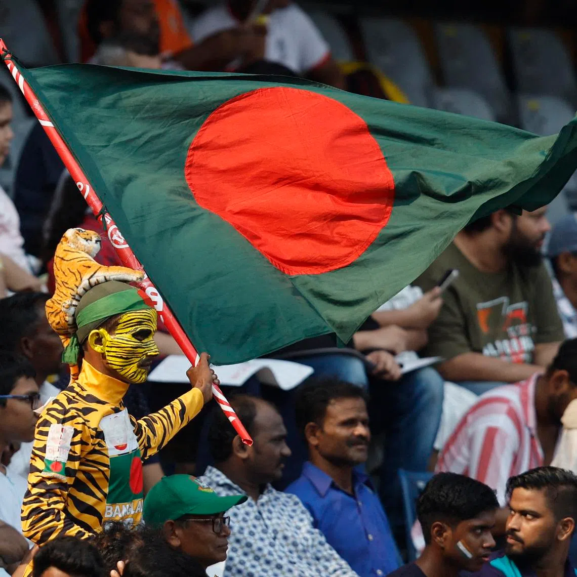 FILE PHOTO: Cricket - ICC Cricket World Cup 2023 - South Africa v Bangladesh - Wankhede Stadium, Mumbai, India - October 24, 2023  A Bangladesh fan with a flag in the stands REUTERS/Francis Mascarenhas/ File Photo
