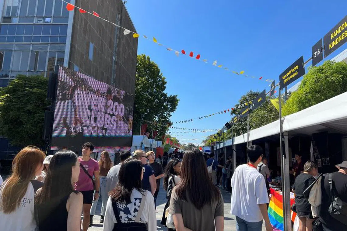 Students walk past stalls during the orientation week at The University of Sydney, in Camperdown, Australia February 15, 2023. REUTERS/ Stella Qiu/File Photo