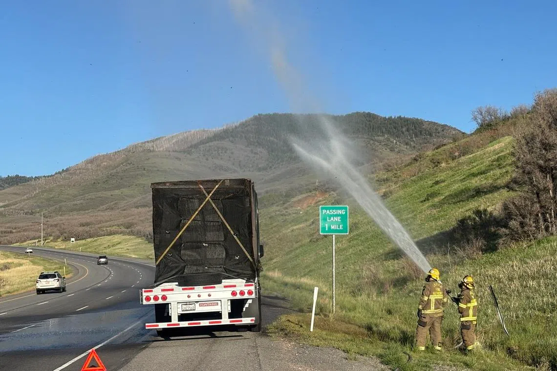 While mechanics worked on the truck, firefighters carefully used a hose to mist the truck’s trailer, which carried 480 hives.