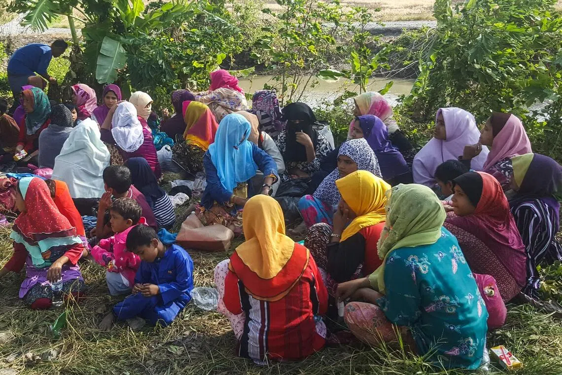 Buses seen under police escort as Malaysia starts sending Myanmar migrants home