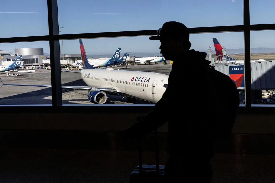 FILE PHOTO: A passenger walks along terminal 2 at the San Francisco International Airport in San Francisco, California , U.S., September 3, 2022. REUTERS/Carlos Barria/File Photo