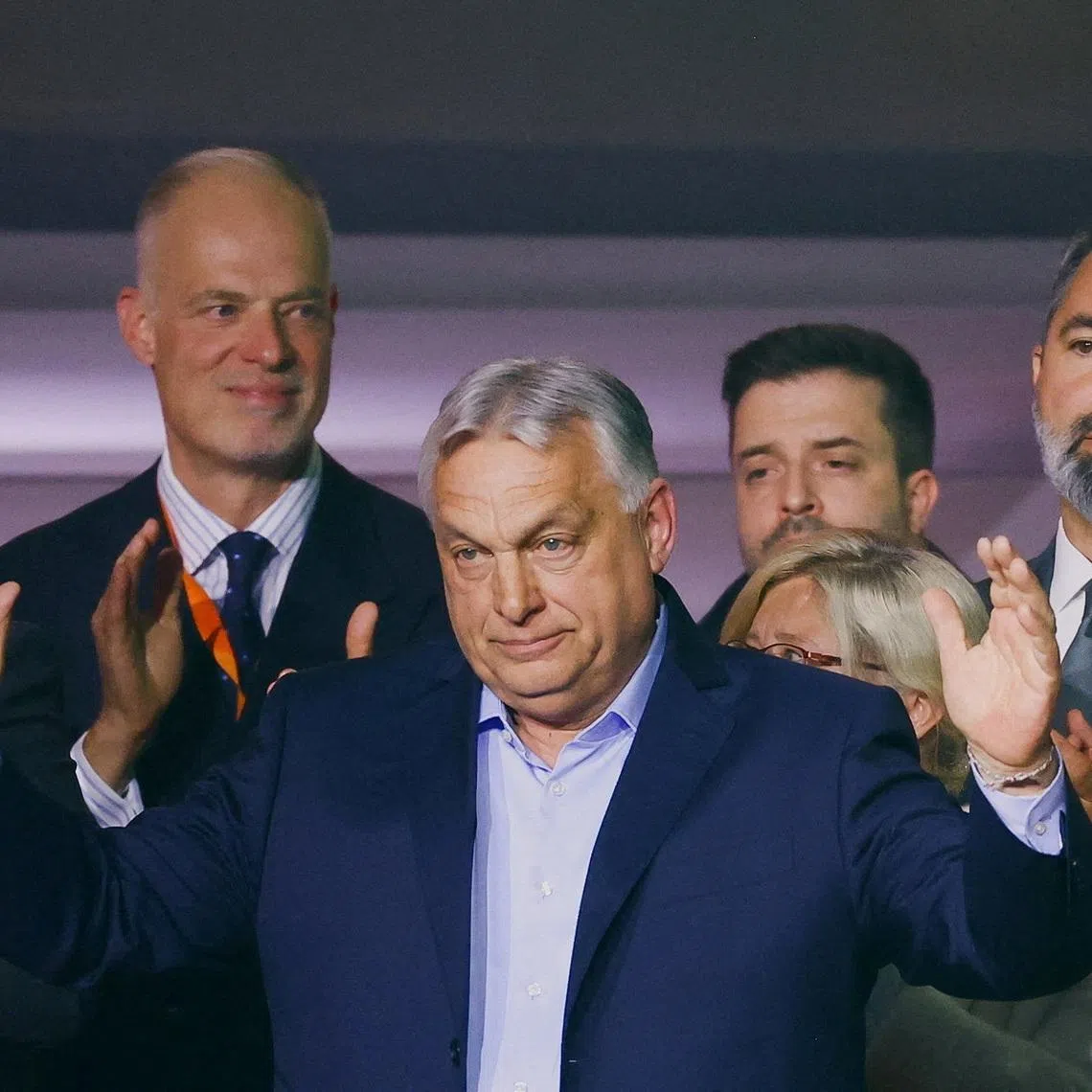Hungarian Prime Minister Viktor Orban reacts onstage as people applaud after the announcement of the partial results of parliamentary election in Budapest, Hungary, April 12, 2026. REUTERS/Bernadett Szabo