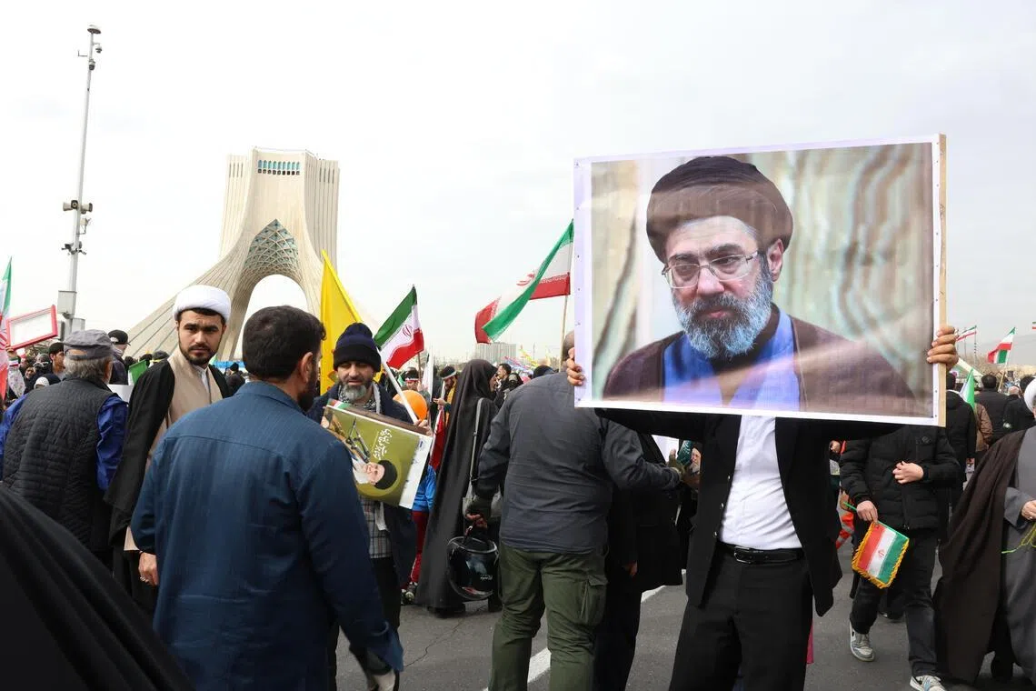 An Iranian holds a portrait of Iran’s new supreme leader, Ayatollah Mojtaba Khamenei.
