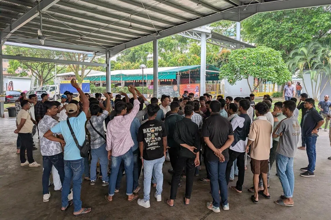 Migrant workers from Process Maintenance Solutions meeting the firm’s director over unpaid wages and their work status at the Migrant Workers’ Centre Recreation Club on Oct 23.