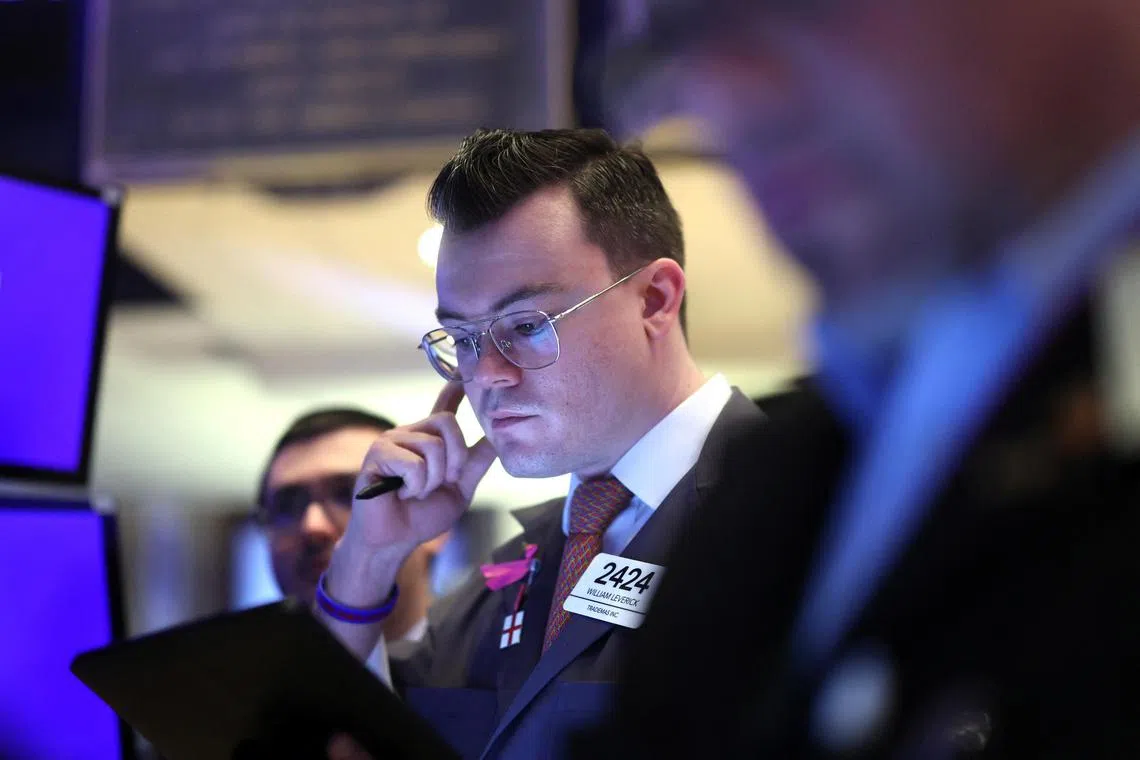 Traders work on the floor of the New York Stock Exchange, in New York City.