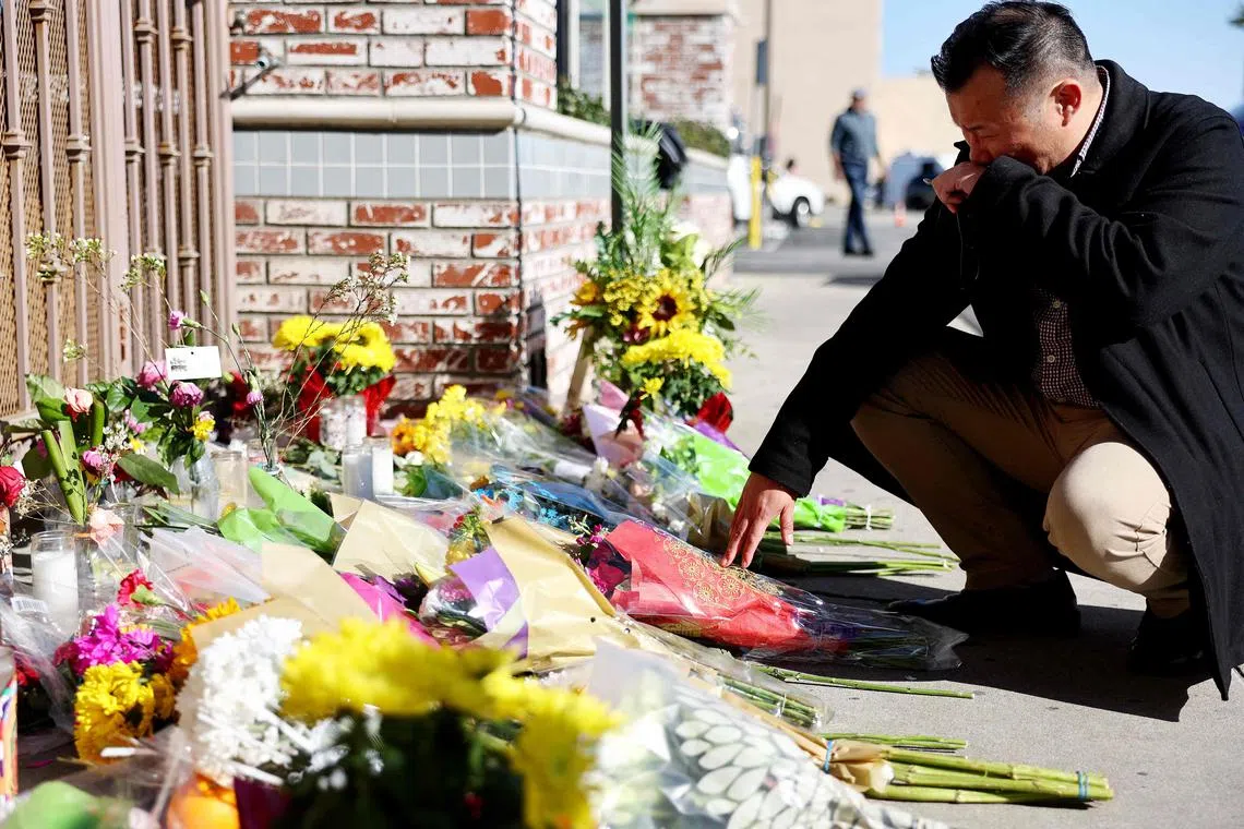 MONTEREY PARK, CALIFORNIA - JANUARY 23: Monterey Park mayor Henry Lo kneels at a makeshift memorial outside the scene of a deadly mass shooting at a ballroom dance studio on January 23, 2023 in Monterey Park, California. An eleventh person has died and ten more were injured at the studio near a Lunar New Year celebration on Saturday night. A candlelight vigil for the victims will be held in the predominantly Asian American community of Monterey Park tonight.   Mario Tama/Getty Images/AFP (Photo by MARIO TAMA / GETTY IMAGES NORTH AMERICA / Getty Images via AFP)