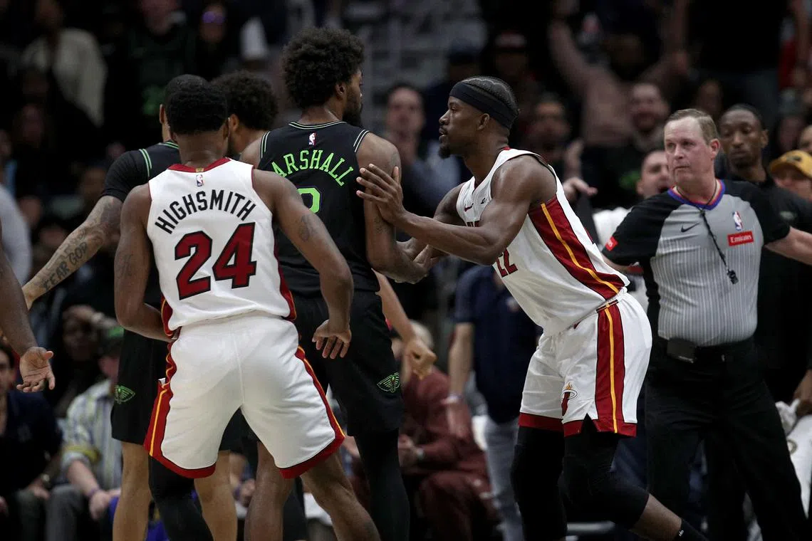 Naji Marshall of the New Orleans Pelicans and Jimmy Butler of the Miami Heat are involved in an altercation during the match.