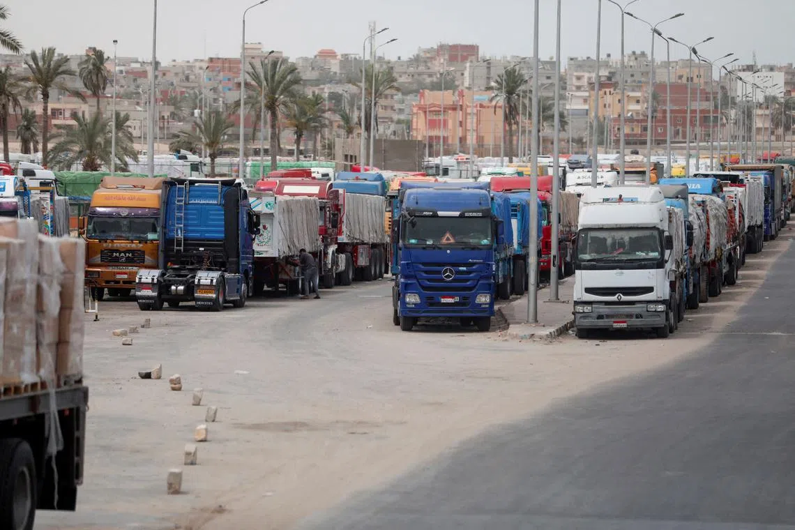 FILE PHOTO: Trucks stand at the Rafah border crossing between Egypt and the Gaza Strip, amid the ongoing conflict between Israel and Palestinian Islamist group Hamas, in Rafah, Egypt, April 25, 2024. REUTERS/Mohamed Abd El Ghany/File Photo
