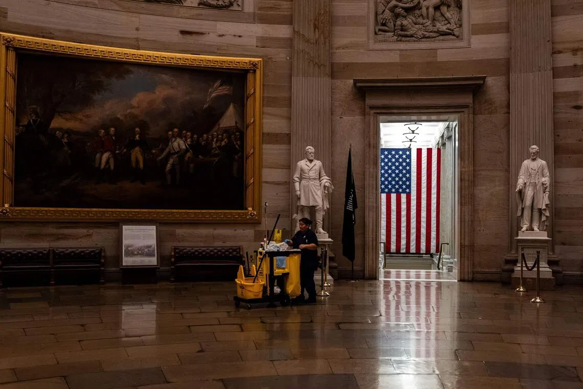 WASHINGTON, DC - SEPTEMBER 30: A maintenance worker pushes a cleaning cart through the rotunda of the U.S. Capitol on September 30, 2025 in Washington, DC. If lawmakers fail to reach a bipartisan compromise then the federal government will shutdown at midnight.   Kent Nishimura/Getty Images/AFP (Photo by Kent Nishimura / GETTY IMAGES NORTH AMERICA / Getty Images via AFP)