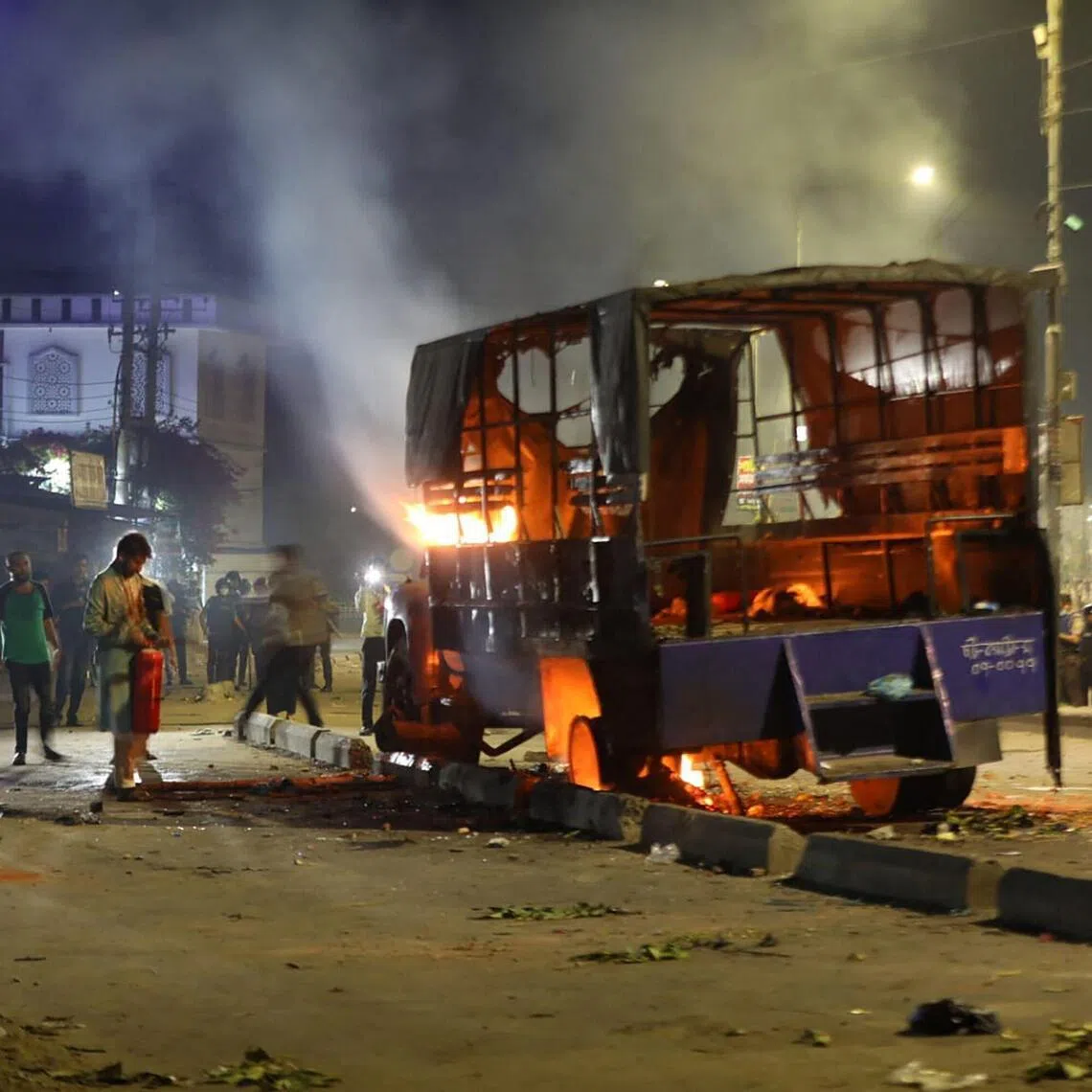 A police vehicle is set ablaze by demonstrators outraged by the rape of a four-year-old girl in Bangladesh.