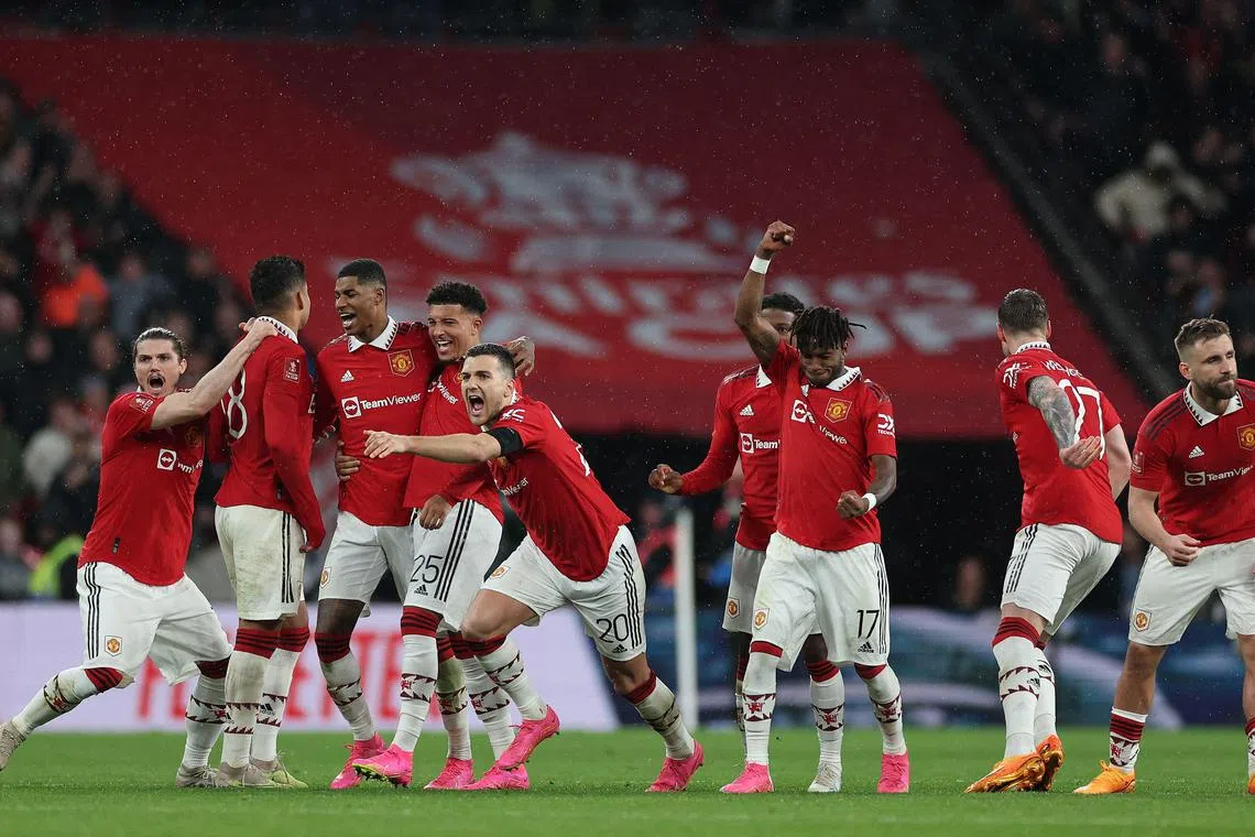 Manchester United players celebrating after winning the penalty shootout against Brighton and Hove Albion in the English FA Cup semi-final.