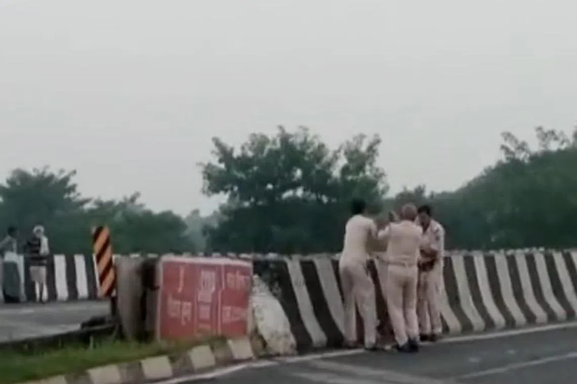 The three policemen were seen carrying the bloodied victim to a bridge barrier before levering him over the edge.