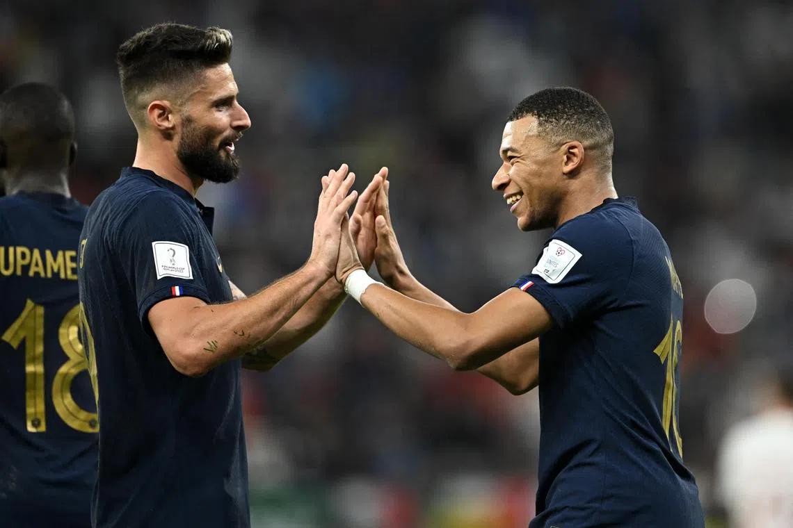 France's Kylian Mbappe celebrates scoring their second goal against Poland with Olivier Giroud. Both strikers found the net in Sunday's World Cup last-16 clash which Les Bleus won 3-1.
