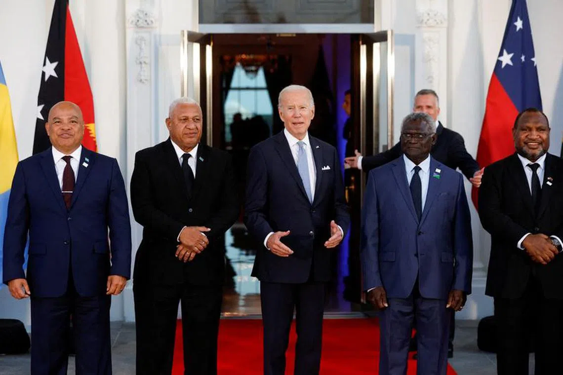 FILE PHOTO: U.S. President Joe Biden speaks as he poses with Federated States of Micronesia's President David Panuelo, Fiji's Prime Minister Frank Bainimarama, Solomon Islands Prime Minister Manasseh Sogavare and Papua New Guinea's Prime Minister James Marape and other leaders from the U.S.- Pacific Island Country Summit, at the White House in Washington, U.S. September 29, 2022. REUTERS/Jonathan Ernst/File Photo