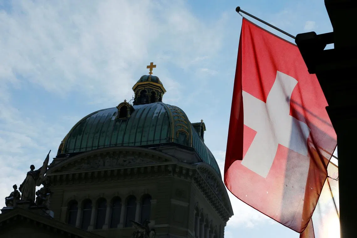 A Swiss flag is pictured in front of the Federal Palace (Bundeshaus) is pictured in Bern, Switzerland, January 16, 2017. REUTERS/Denis Balibouse/File Photo