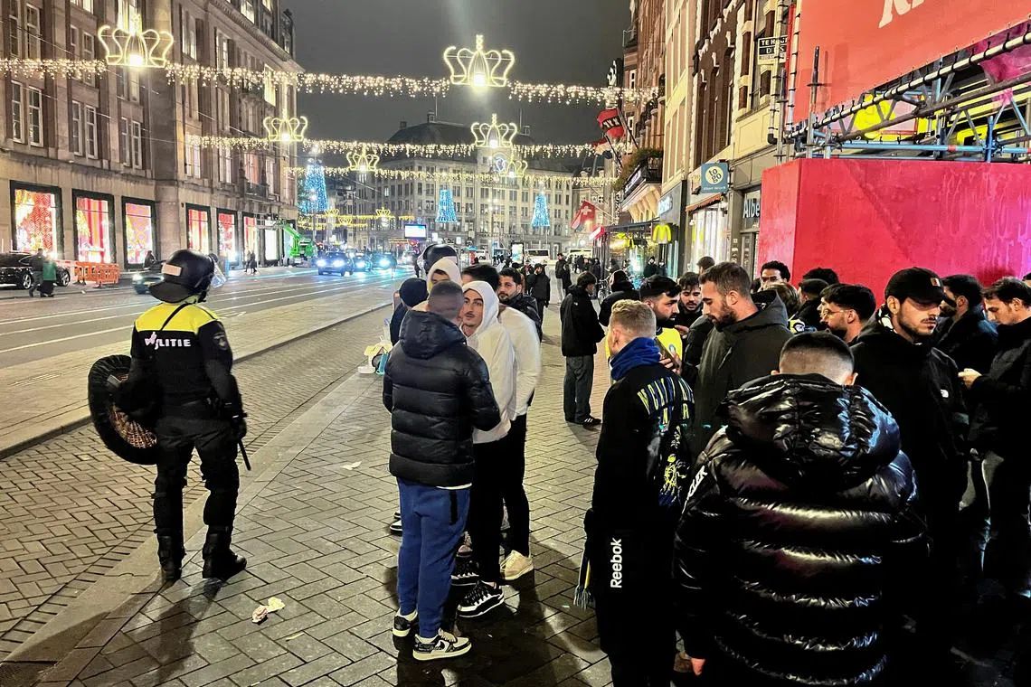 Israeli Maccabi Tel Aviv supporters are guarded by police after violence targeting Israeli football fans broke out in Amsterdam overnight, in Amsterdam, Netherlands, November 8, 2024. REUTERS/Ami Shooman/Israel Hayom