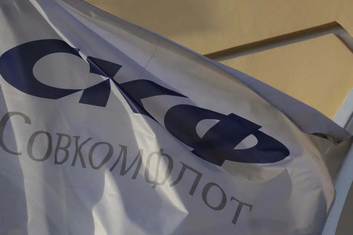 FILE PHOTO: A flag depicting the logo of the Russian state-owned shipping conglomerate Sovcomflot, flies outside the company's hearquarters in St. Petersburg, Russia, May 17, 2017. Picture taken  May 17, 2017. REUTERS/Anton Vaganov/File Photo