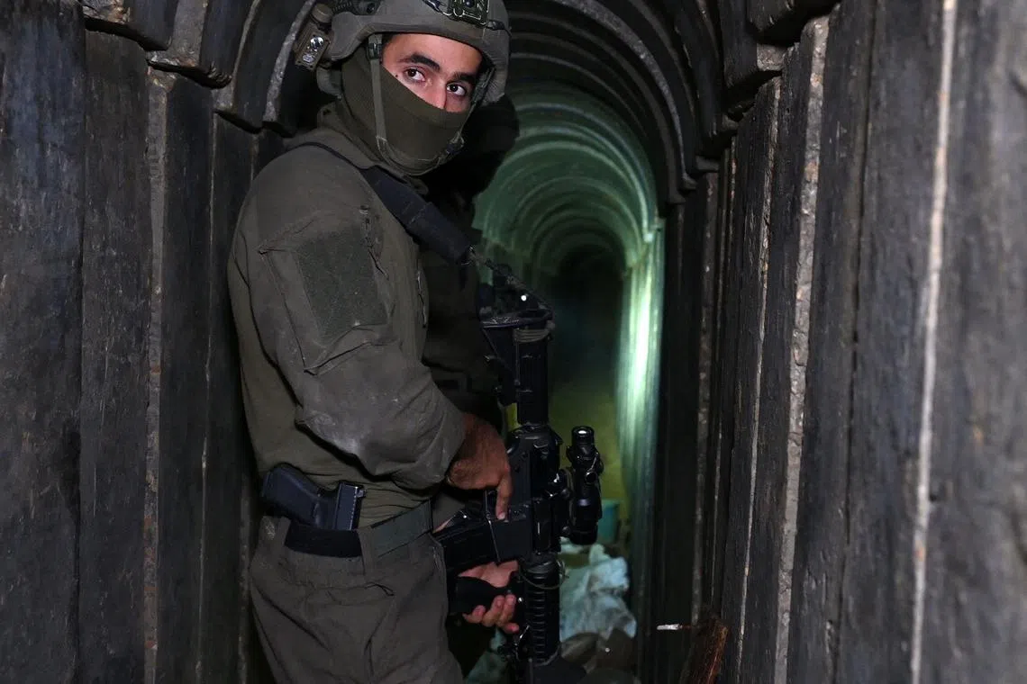 A soldier stands in what the Israeli army says is a tunnel dug by Hamas militants inside the Al-Shifa Hospital complex, in the northern Gaza Strip.
