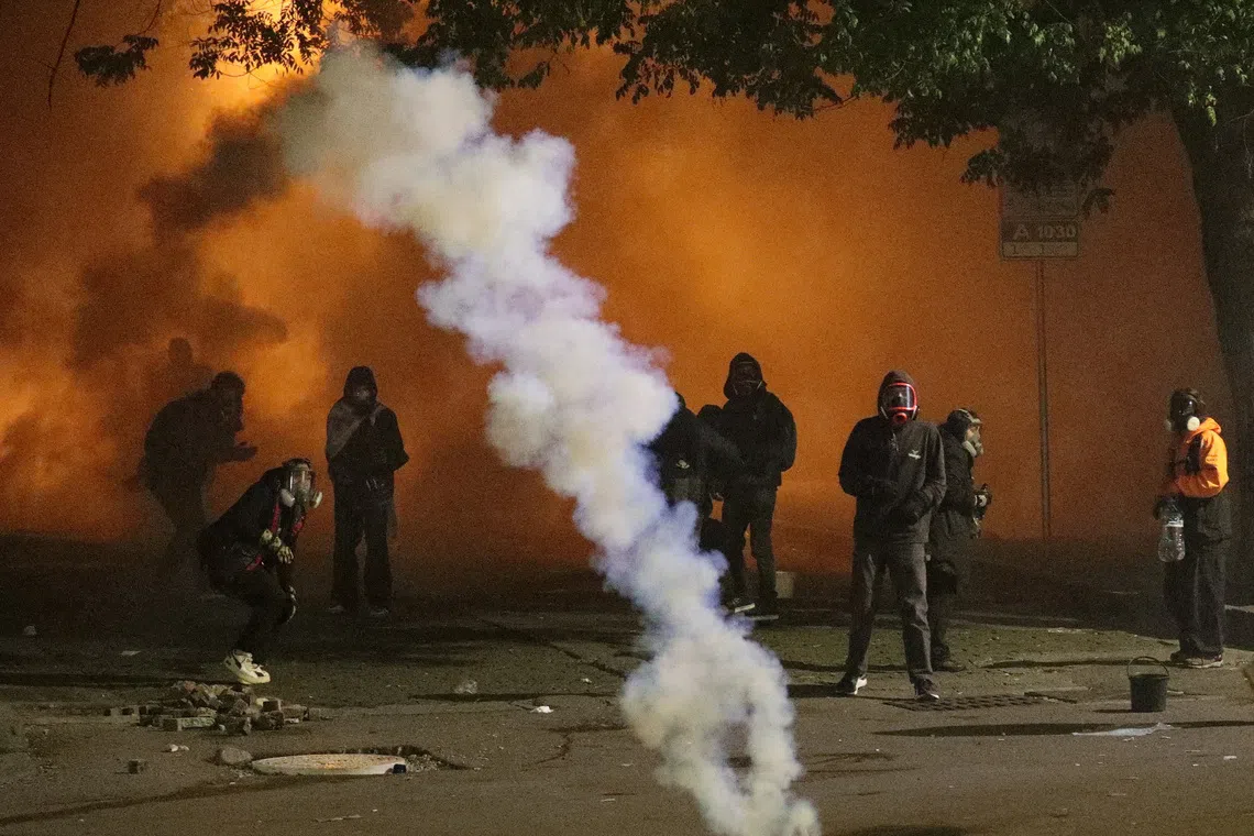Protesters react to tear gas during an opposition rally on the day of local elections in Tbilisi, Georgia October 4, 2025. REUTERS/Irakli Gedenidze