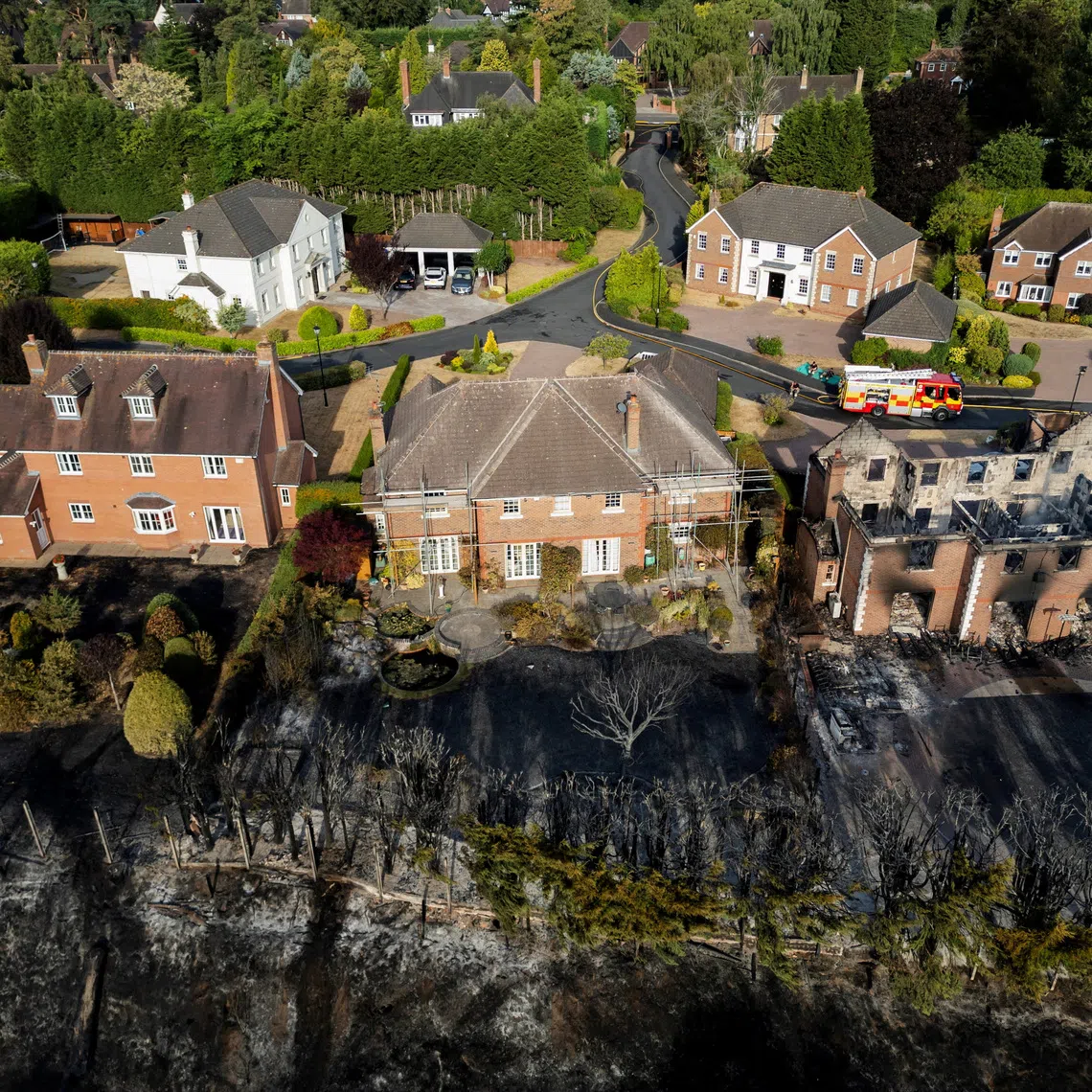A drone view of a burnt-out house following a large grass fire which spread to several homes yesterday during the hottest day of the year, in Stourbridge, West Midlands, Britain, August 14, 2026. REUTERS/Temilade Adelaja