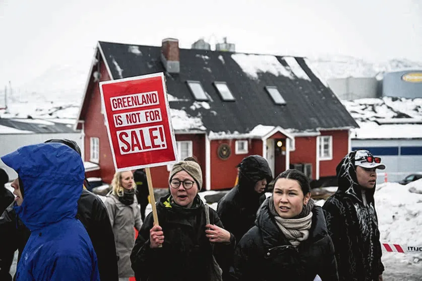 Young people with placards reading "Greenland is not for sale!" take part in a demonstration against the US President's plans to take Greenland, on Jan 17, 2026 in Nuuk, Greenland.