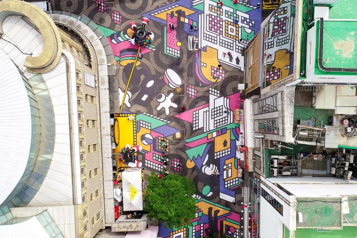 Massive street paintings on the main street of Myeongdong, a major tourist shopping destination in Seoul, South Korea on May 04, 2023 as part of the street's ongoing sales festival.  