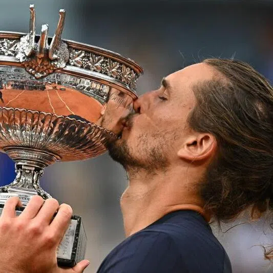 Germany's Alexander Zverev kisses the trophy after winning the French Open tennis tournament men's singles final match against Italy's Flavio Cobolli at Roland Garros.