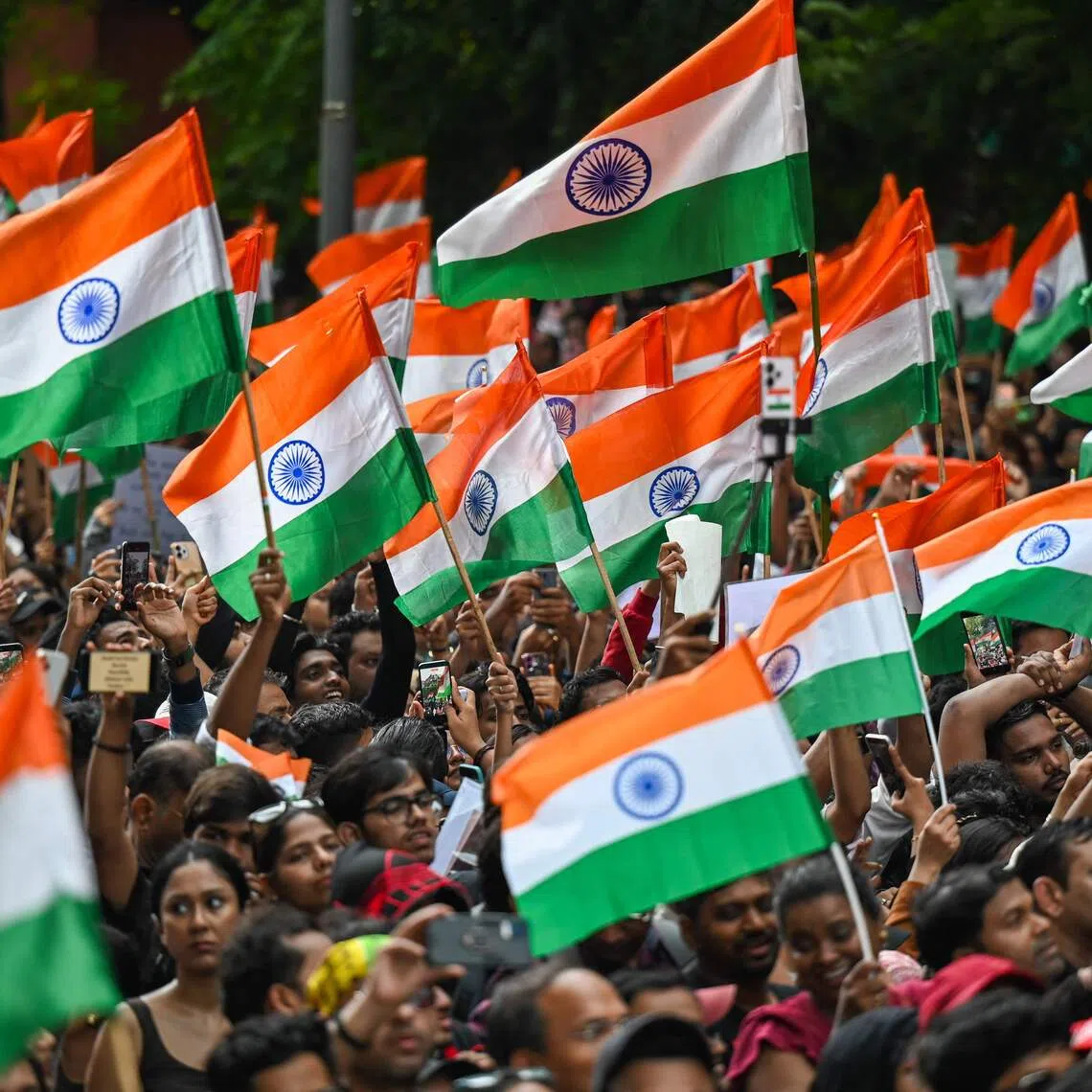 Cockroach Janta Party (CJP) supporters wave flags a day after the resignation of India’s Education Minister Dharmendra Pradhan on July 26.