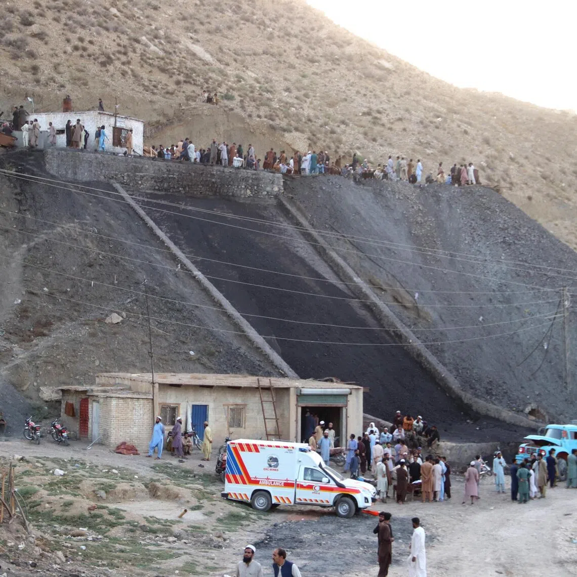 Rescue workers and locals gather at a coal mine after a blast on the outskirts of Quetta, Pakistan, on July 30.