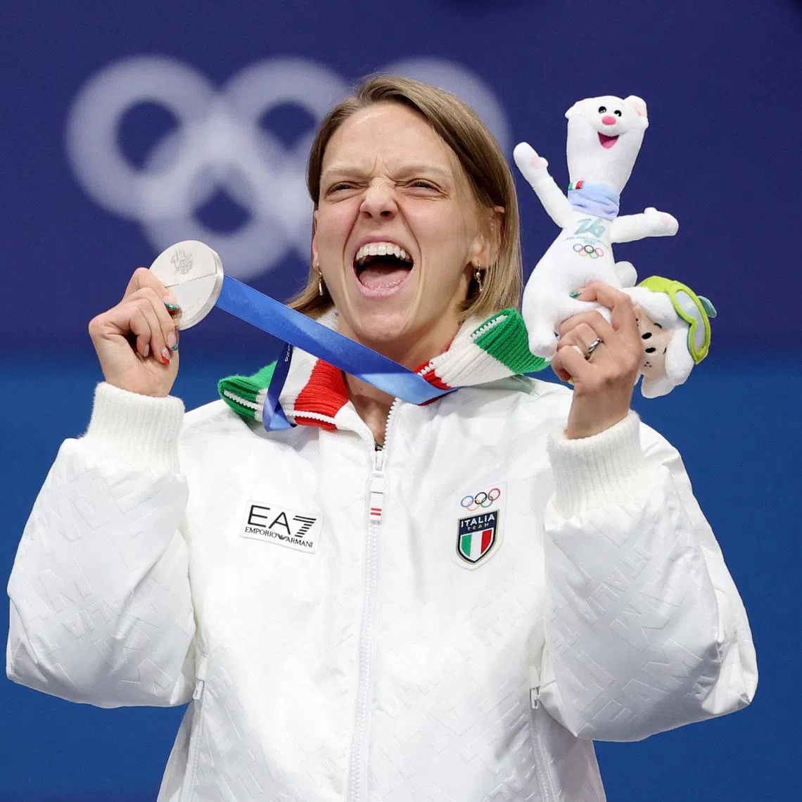 Milano Cortina 2026 Olympics - Short Track Speed Skating - Women's 500m - Victory Ceremony - Milano Ice Skating Arena, Milan, Italy - February 12, 2026. Silver medallist Arianna Fontana of Italy celebrates on the podium after finishing second in the Women's 500m REUTERS/Claudia Greco