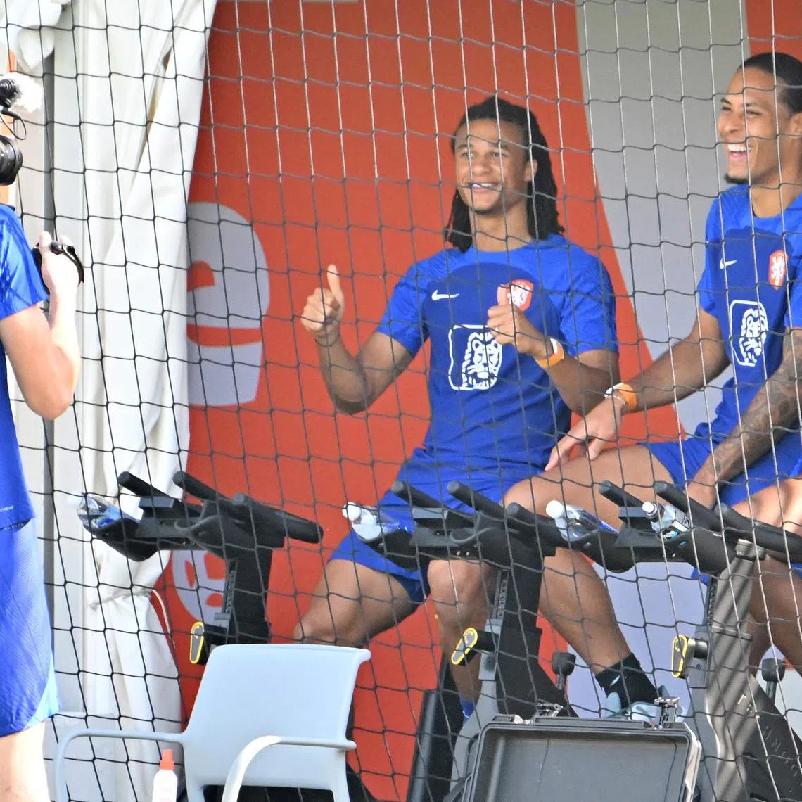 Netherlands' goalkeeper Andries Noppert "filming" teammates Nathan Ake and Virgil van Dijk during a training session on Dec 4.