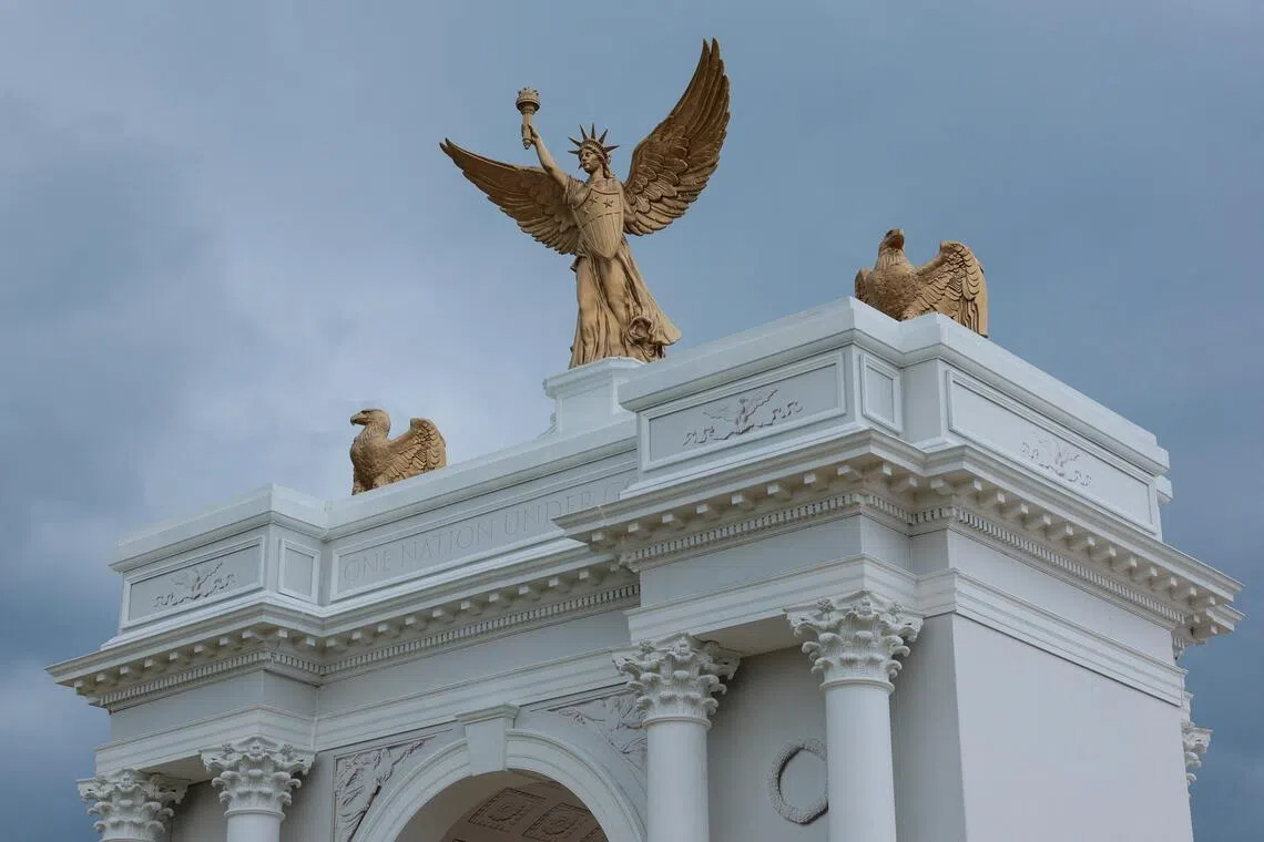 A large white monument with bronze eagles and a central winged figure.
