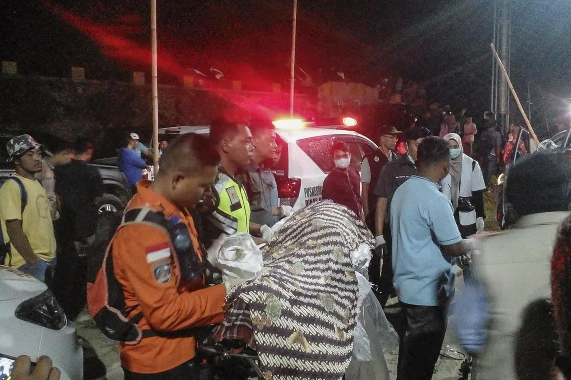 Rescuers and paramedics carry the body of a victim following a landslide in Sungai Abu, Solok, West Java, Indonesia, on Sept 27, 2024.