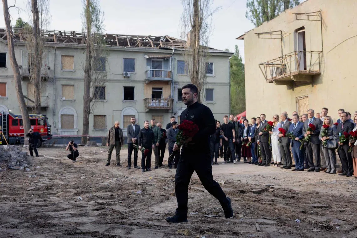 Ukrainian President Volodymyr Zelensky visiting the site of a Russian missile attack in Kyiv on April 25.