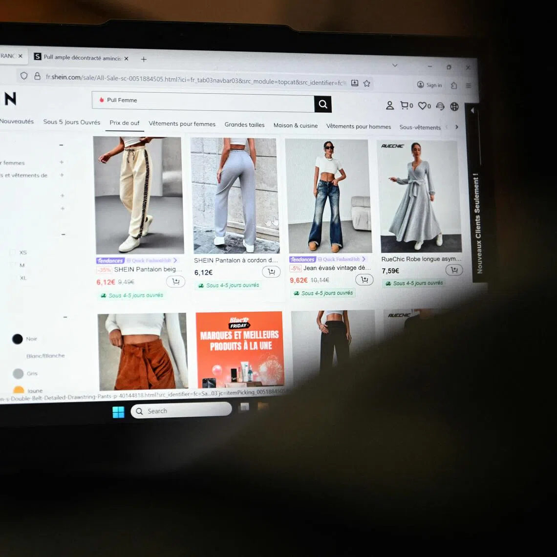 An internet user checks the Asian e-commerce giant Shein website page on a laptop.