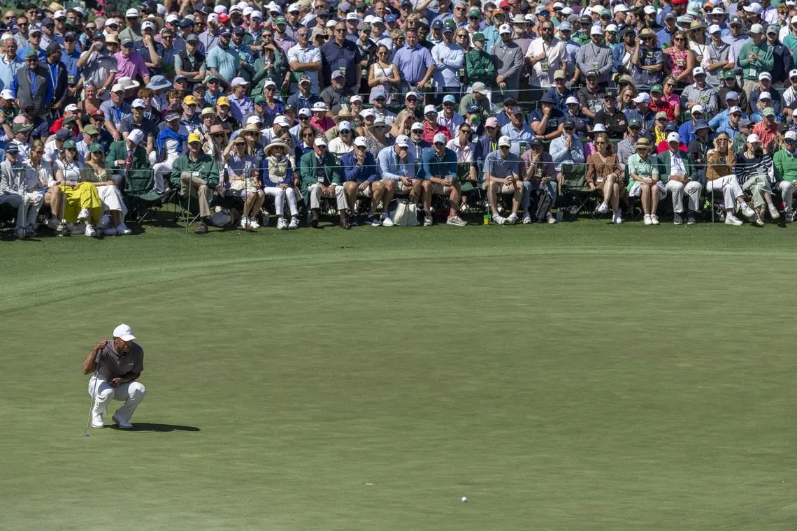 A huge crowd gathers to watch Tiger Woods on the No. 18 green during the second round of the 2024 Masters.